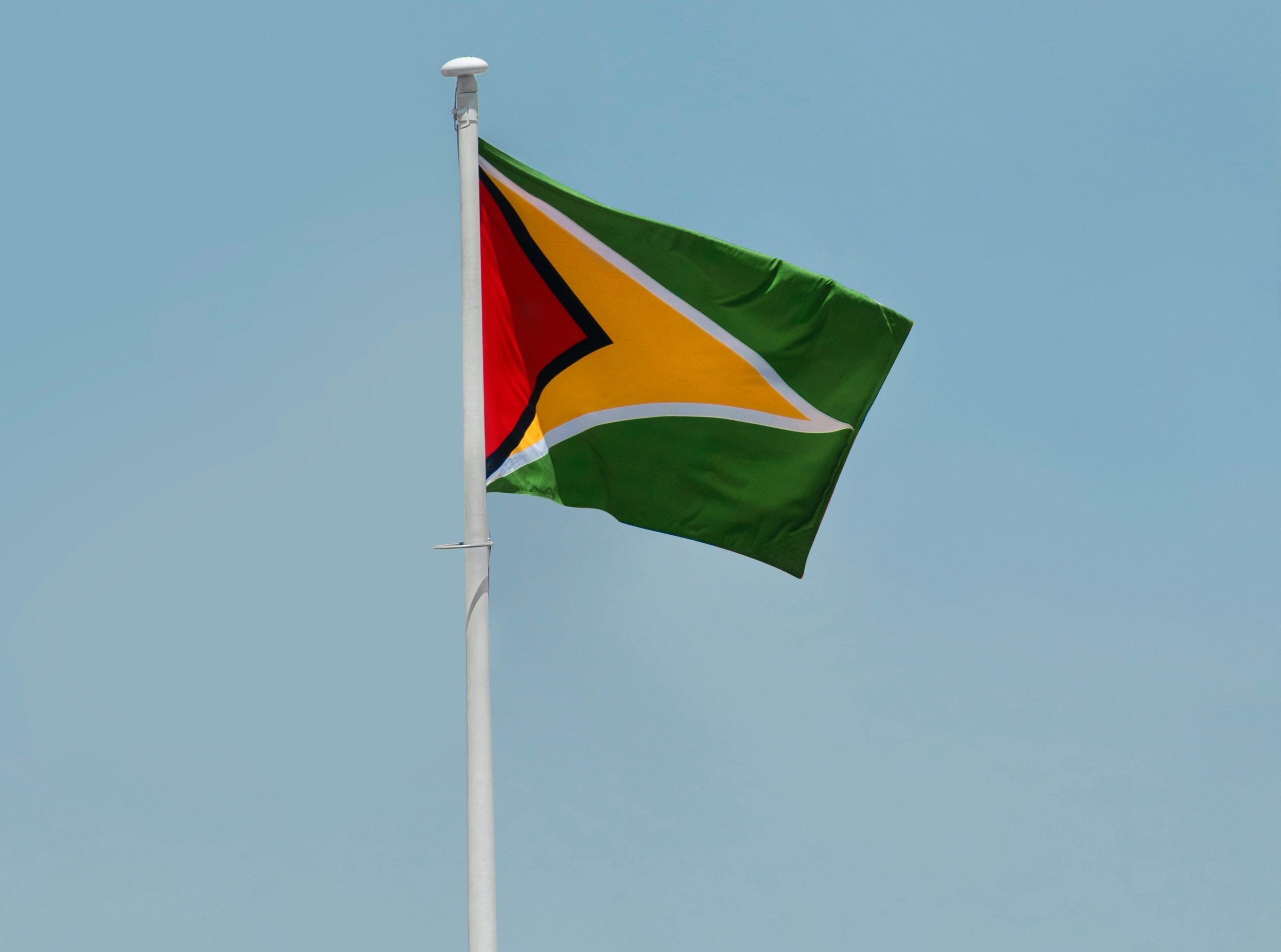 Guyana flag Flag of Guyana flying on a flag pole